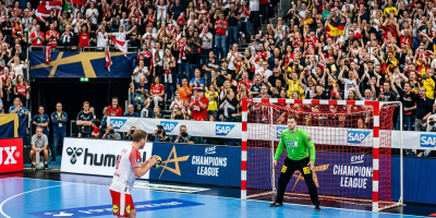 Handball penalty setup blue court red white goal crowd