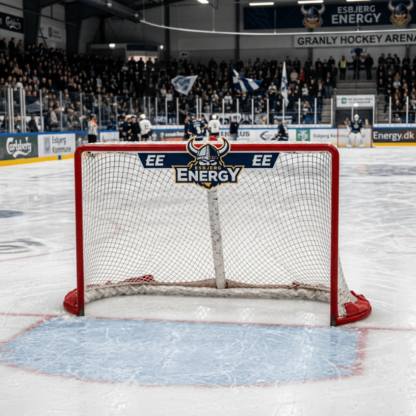 Hockey goal bearing the Esbjerg Energy logo before a crowded arena