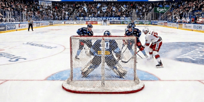 Ice hockey players compete near the goal during Sønderjyske versus Rødovre
